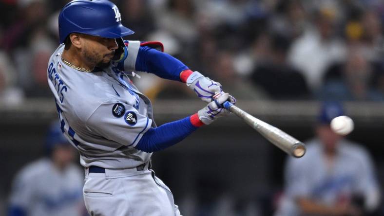 Sep 29, 2022; San Diego, California, USA; Los Angeles Dodgers right fielder Mookie Betts (50) hits a double against the San Diego Padres during the sixth inning at Petco Park. Mandatory Credit: Orlando Ramirez-USA TODAY Sports