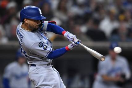 Sep 29, 2022; San Diego, California, USA; Los Angeles Dodgers right fielder Mookie Betts (50) hits a double against the San Diego Padres during the sixth inning at Petco Park. Mandatory Credit: Orlando Ramirez-USA TODAY Sports