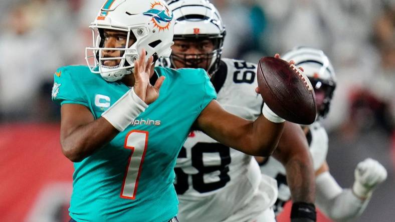 Miami Dolphins quarterback Tua Tagovailoa (1) is pursued by Cincinnati Bengals defensive tackle Josh Tupou (68) in the second quarter of the NFL Week 4 game between the Cincinnati Bengals and the Miami Dolphins at PayCor Stadium in downtown on Thursday, Sept. 29, 2022. The Bengals 14-12 at halftime.

Miami Dolphins At Cincinnati Bengals Week 4