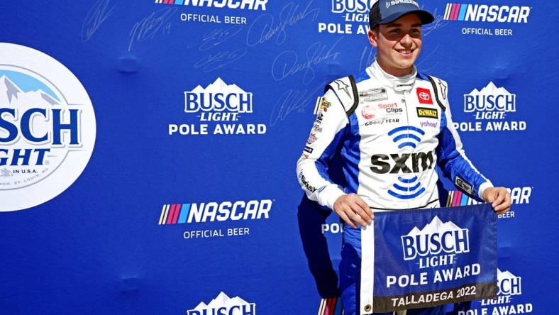 Oct 1, 2022; Talladega, Alabama, USA; NASCAR Cup Series driver Christopher Bell (20) celebrates winning the pole during qualifying for the YellaWood 500 at Talladega Superspeedway. Mandatory Credit: John David Mercer-USA TODAY Sports