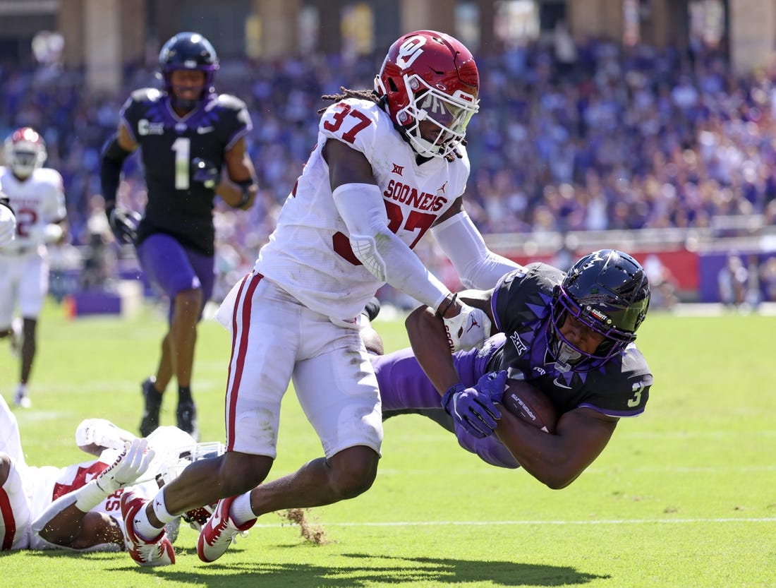 Oct 1, 2022; Fort Worth, Texas, USA;  TCU Horned Frogs running back Emari Demercado (3) dives for yardage as Oklahoma Sooners defensive back Justin Harrington (37) defends during the first half at Amon G. Carter Stadium. Mandatory Credit: Kevin Jairaj-USA TODAY Sports