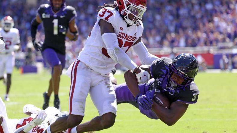 Oct 1, 2022; Fort Worth, Texas, USA;  TCU Horned Frogs running back Emari Demercado (3) dives for yardage as Oklahoma Sooners defensive back Justin Harrington (37) defends during the first half at Amon G. Carter Stadium. Mandatory Credit: Kevin Jairaj-USA TODAY Sports