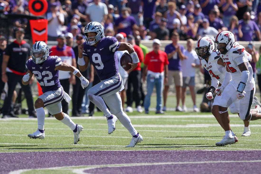 Oct 1, 2022; Manhattan, Kansas, USA; Kansas State Wildcats quarterback Adrian Martinez (9) breaks away from several Texas Tech Red Raiders defenders on his way to a touchdown in the fourth quarter at Bill Snyder Family Football Stadium. Mandatory Credit: Scott Sewell-USA TODAY Sports