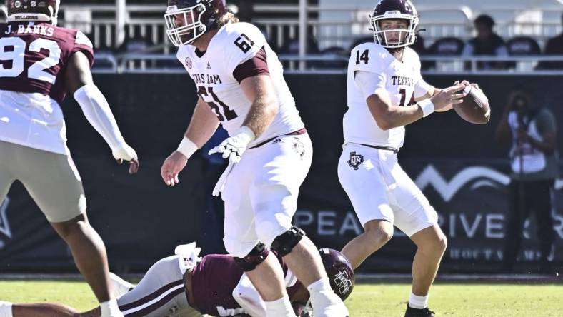 Oct 1, 2022; Starkville, Mississippi, USA; Texas A&M Aggies quarterback Max Johnson (14) looks to pass against the Mississippi State Bulldogs during the first quarter at Davis Wade Stadium at Scott Field. Mandatory Credit: Matt Bush-USA TODAY Sports