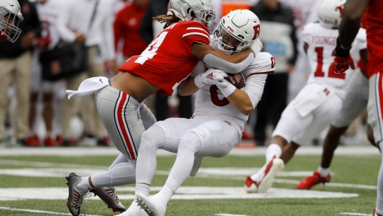 Oct 1, 2022; Columbus, Ohio, USA;  Ohio State Buckeyes safety Ronnie Hickman (14) tackles Rutgers Scarlet Knights quarterback Noah Vedral (0) for a loss during the first quarter at Ohio Stadium. Mandatory Credit: Joseph Maiorana-USA TODAY Sports