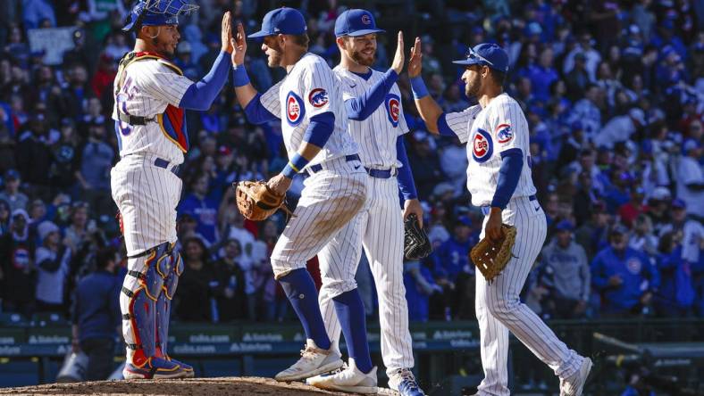 Oct 1, 2022; Chicago, Illinois, USA; Chicago Cubs players celebrate the win against the Cincinnati Reds at Wrigley Field. Mandatory Credit: Kamil Krzaczynski-USA TODAY Sports