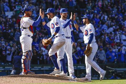 Oct 1, 2022; Chicago, Illinois, USA; Chicago Cubs players celebrate the win against the Cincinnati Reds at Wrigley Field. Mandatory Credit: Kamil Krzaczynski-USA TODAY Sports