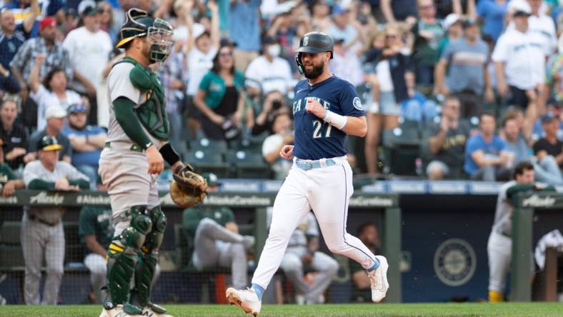 Oct 1, 2022; Seattle, Washington, USA; Seattle Mariners left fielder Jesse Winker (27) scores a run off a single hit by Seattle Mariners catcher Luis Torrens (22) (not pictured) during the eighth inning at T-Mobile Park. Mandatory Credit: Steven Bisig-USA TODAY Sports