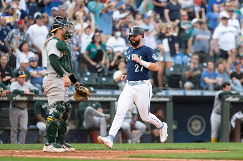 Oct 1, 2022; Seattle, Washington, USA; Seattle Mariners left fielder Jesse Winker (27) scores a run off a single hit by Seattle Mariners catcher Luis Torrens (22) (not pictured) during the eighth inning at T-Mobile Park. Mandatory Credit: Steven Bisig-USA TODAY Sports