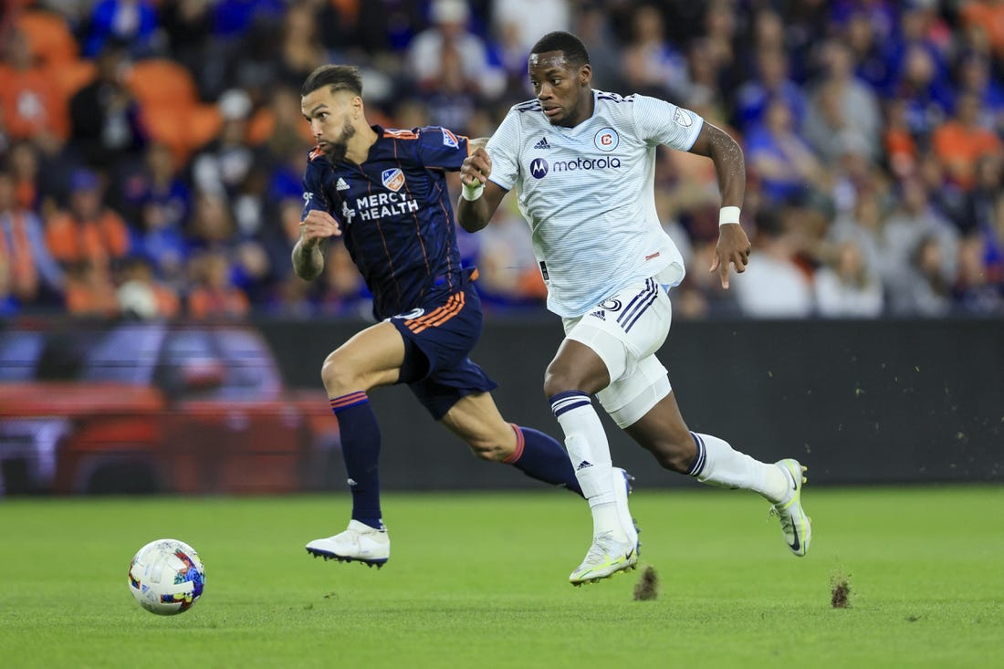 Oct 1, 2022; Cincinnati, Ohio, USA;  FC Cincinnati defender Geoff Cameron (left) chase as Chicago Fire forward Jhon Duran (26) controls the ball in the second half at TQL Stadium. Mandatory Credit: Aaron Doster-USA TODAY Sports