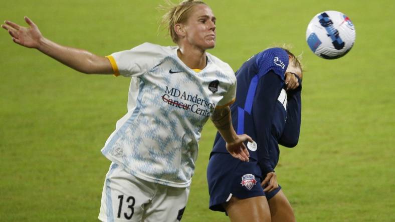 Oct 1, 2022; Washington, District of Columbia, USA; Houston Dash Sophie Schmidt (13) and Washington Spirit forward Trinity Rodman (2) battle for the ball in the second half at Audi Field. Mandatory Credit: Amber Searls-USA TODAY Sports