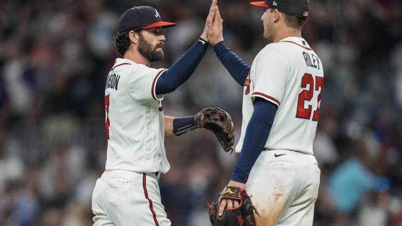 Oct 1, 2022; Cumberland, Georgia, USA; Atlanta Braves shortstop Dansby Swanson (7) reacts with third baseman Austin Riley (27) after the Braves defeated the New York Mets at Truist Park. Mandatory Credit: Dale Zanine-USA TODAY Sports