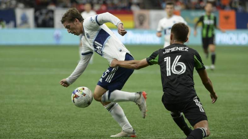 Oct 1, 2022; Vancouver, British Columbia, CAN;  Vancouver Whitecaps FC midfielder Ryan Gauld (25) takes possession of the ball against Austin FC midfielder Hector Jimenez (16) during the first half at BC Place. Mandatory Credit: Anne-Marie Sorvin-USA TODAY Sports