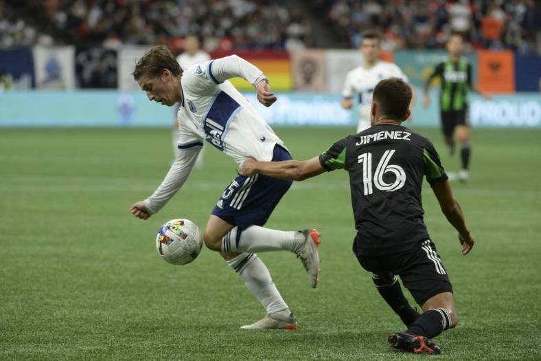 Oct 1, 2022; Vancouver, British Columbia, CAN;  Vancouver Whitecaps FC midfielder Ryan Gauld (25) takes possession of the ball against Austin FC midfielder Hector Jimenez (16) during the first half at BC Place. Mandatory Credit: Anne-Marie Sorvin-USA TODAY Sports