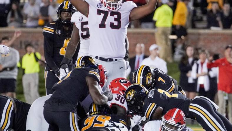 Oct 1, 2022; Columbia, Missouri, USA; Georgia Bulldogs running back Daijun Edwards (30) sores against the Missouri Tigers as offensive lineman Xavier Truss (73) celebrates during the first half at Faurot Field at Memorial Stadium. Mandatory Credit: Denny Medley-USA TODAY Sports