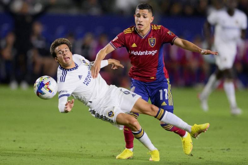 Oct 1, 2022; Carson, California, USA; LA Galaxy midfielder Ricard Puig (6) is fouled by Real Salt Lake forward Jefferson Savarino (11) during the first half at Dignity Health Sports Park. Mandatory Credit: Kelvin Kuo-USA TODAY Sports