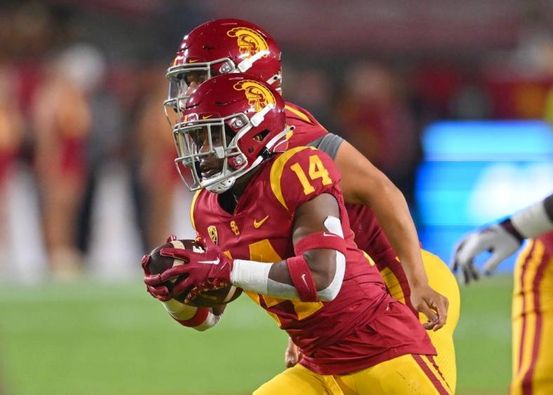 Oct 1, 2022; Los Angeles, California, USA;  USC Trojans running back Raleek Brown (14) takes a hand off from quarterback Caleb Williams (13) the first half against the Arizona State Sun Devils at United Airlines Field at the Los Angeles Memorial Coliseum. Mandatory Credit: Jayne Kamin-Oncea-USA TODAY Sports