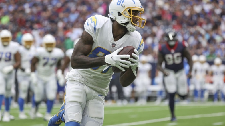 Oct 2, 2022; Houston, Texas, USA; Los Angeles Chargers wide receiver Mike Williams (81) runs with the ball after a reception during the second quarter against the Houston Texans at NRG Stadium. Mandatory Credit: Troy Taormina-USA TODAY Sports