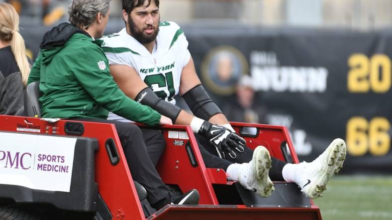 Oct 2, 2022; Pittsburgh, Pennsylvania, USA;  New York Jets offensive lineman Max Mitchell (61) is carted off the field after being injured against the Pittsburgh Steelers during the second quarter at Acrisure Stadium. Mandatory Credit: Philip G. Pavely-USA TODAY Sports