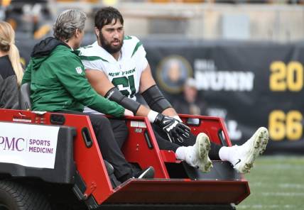 Oct 2, 2022; Pittsburgh, Pennsylvania, USA;  New York Jets offensive lineman Max Mitchell (61) is carted off the field after being injured against the Pittsburgh Steelers during the second quarter at Acrisure Stadium. Mandatory Credit: Philip G. Pavely-USA TODAY Sports