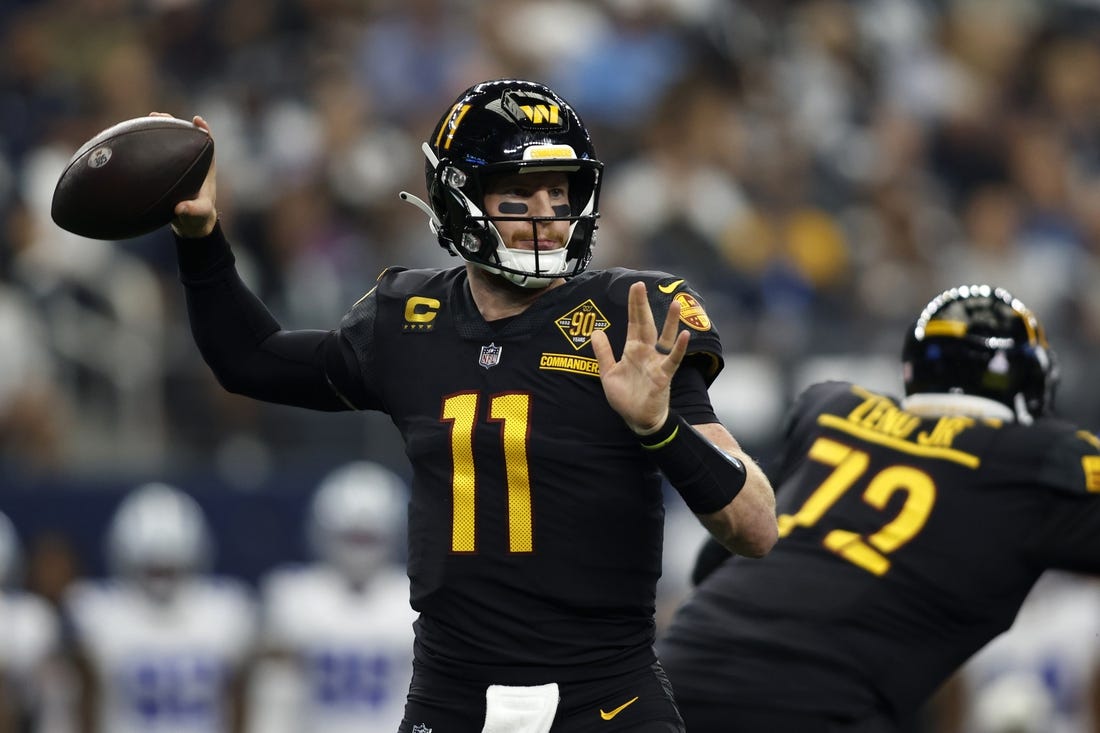 Oct 2, 2022; Arlington, Texas, USA; Washington Commanders quarterback Carson Wentz (11) throws a pass in the second quarter against the Dallas Cowboys at AT&T Stadium. Mandatory Credit: Tim Heitman-USA TODAY Sports