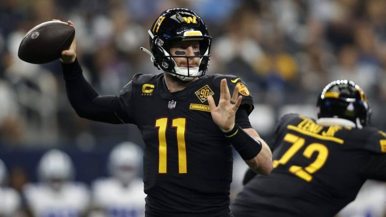 Oct 2, 2022; Arlington, Texas, USA; Washington Commanders quarterback Carson Wentz (11) throws a pass in the second quarter against the Dallas Cowboys at AT&T Stadium. Mandatory Credit: Tim Heitman-USA TODAY Sports