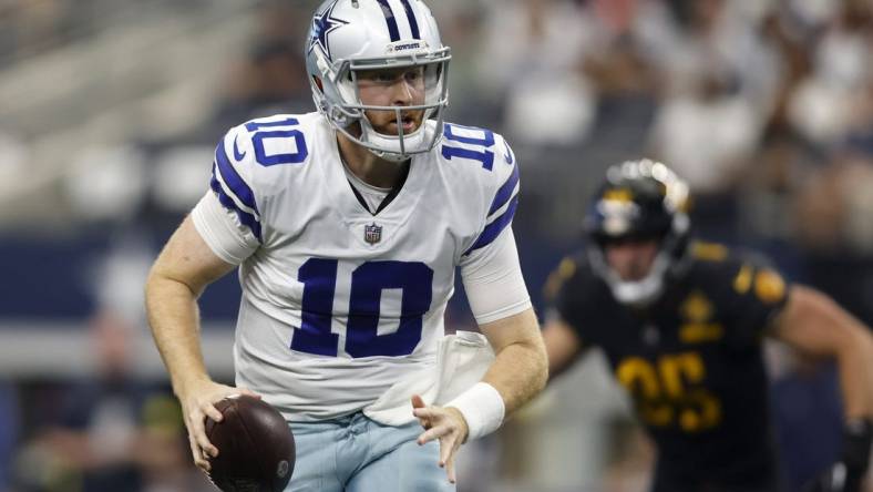 Oct 2, 2022; Arlington, Texas, USA; Dallas Cowboys quarterback Cooper Rush (10) scrambles for a first down in the game against the Washington Commanders at AT&T Stadium. Mandatory Credit: Tim Heitman-USA TODAY Sports