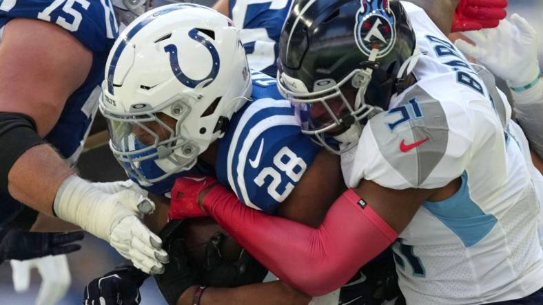 Oct 2, 2022; Indianapolis, Indiana, USA; Tennessee Titans safety Kevin Byard (31) works to bring down Indianapolis Colts running back Jonathan Taylor (28) during the first half at Lucas Oil Stadium. Mandatory Credit: Jenna Watson/IndyStar-USA TODAY NETWORK