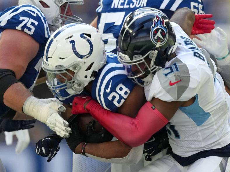 Oct 2, 2022; Indianapolis, Indiana, USA; Tennessee Titans safety Kevin Byard (31) works to bring down Indianapolis Colts running back Jonathan Taylor (28) during the first half at Lucas Oil Stadium. Mandatory Credit: Jenna Watson/IndyStar-USA TODAY NETWORK