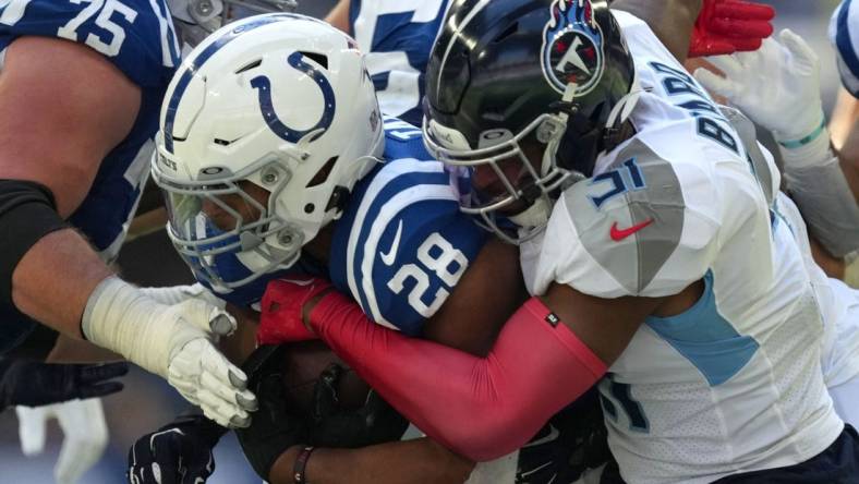 Tennessee Titans safety Kevin Byard (31) works to bring down Indianapolis Colts running back Jonathan Taylor (28) on Sunday, Oct. 2, 2022, during a game against the Tennessee Titans at Lucas Oil Stadium in Indianapolis.