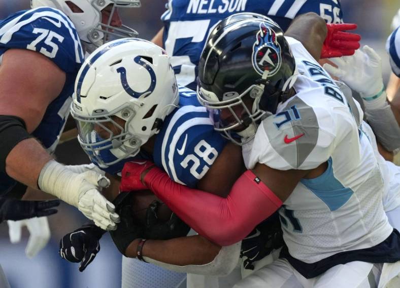 Tennessee Titans safety Kevin Byard (31) works to bring down Indianapolis Colts running back Jonathan Taylor (28) on Sunday, Oct. 2, 2022, during a game against the Tennessee Titans at Lucas Oil Stadium in Indianapolis.