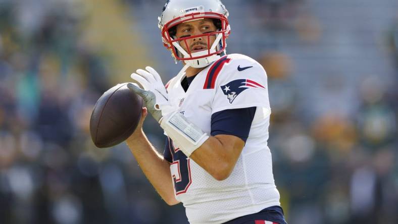 Oct 2, 2022; Green Bay, Wisconsin, USA;  New England Patriots quarterback Brian Hoyer (5) throws a pass during warmups prior to the game against the Green Bay Packers at Lambeau Field. Mandatory Credit: Jeff Hanisch-USA TODAY Sports