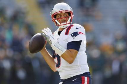 Oct 2, 2022; Green Bay, Wisconsin, USA;  New England Patriots quarterback Brian Hoyer (5) throws a pass during warmups prior to the game against the Green Bay Packers at Lambeau Field. Mandatory Credit: Jeff Hanisch-USA TODAY Sports