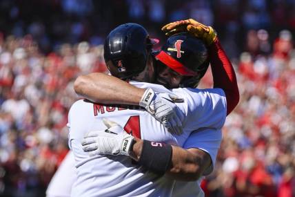 Oct 2, 2022; St. Louis, Missouri, USA;  St. Louis Cardinals first baseman Albert Pujols (5) celebrates with catcher Yadier Molina (4) after hitting a solo home run for his 702nd career home run during the third inning against the Pittsburgh Pirates at Busch Stadium. Mandatory Credit: Jeff Curry-USA TODAY Sports
