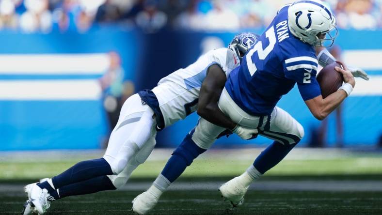 Oct 2, 2022; Indianapolis, Indiana, USA; Indianapolis Colts quarterback Matt Ryan (2) is tackled by Tennessee Titans cornerback Roger McCreary (21) during the second half at Lucas Oil Stadium. Mandatory Credit: Jenna Watson/IndyStar-USA TODAY NETWORK