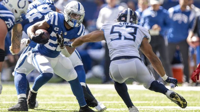 Oct 2, 2022; Indianapolis, Indiana, USA;  Indianapolis Colts running back Jonathan Taylor (28) looks to evade Tennessee Titans linebacker Dylan Cole (53) during the second half at Lucas Oil Stadium. Titans won 24 to 17.  Mandatory Credit: Marc Lebryk-USA TODAY Sports