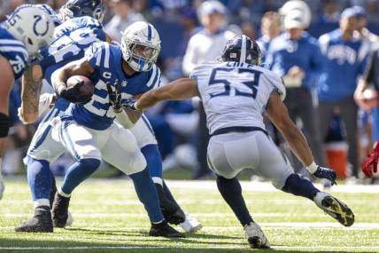 Oct 2, 2022; Indianapolis, Indiana, USA;  Indianapolis Colts running back Jonathan Taylor (28) looks to evade Tennessee Titans linebacker Dylan Cole (53) during the second half at Lucas Oil Stadium. Titans won 24 to 17.  Mandatory Credit: Marc Lebryk-USA TODAY Sports