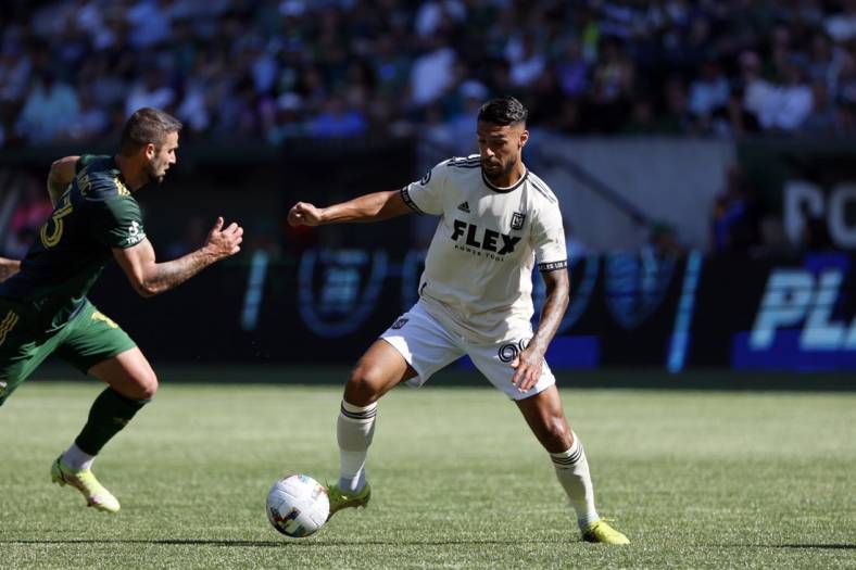 Oct 2, 2022; Portland, Oregon, USA; LAFC forward Denis Bouanga (99) controls the ball against Portland Timbers defender Dario Zuparic (13) during the first half at Providence Park. Mandatory Credit: Soobum Im-USA TODAY Sports