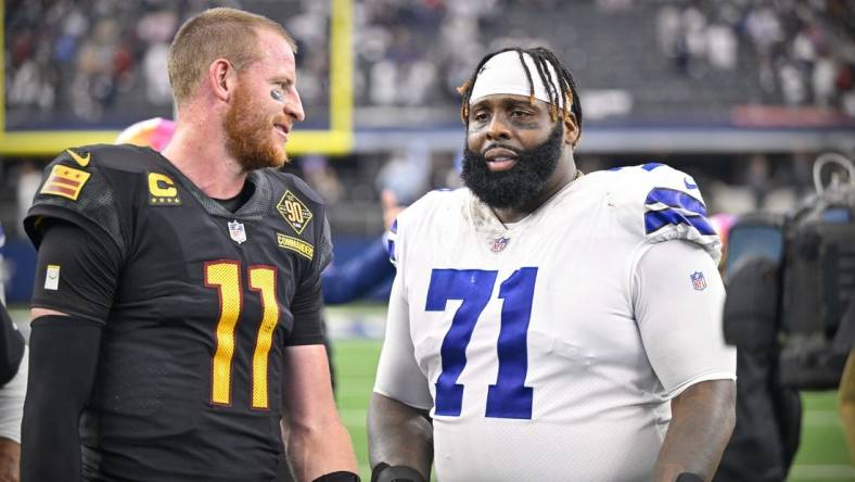 Oct 2, 2022; Arlington, Texas, USA; Washington Commanders quarterback Carson Wentz (11) talks with Dallas Cowboys offensive tackle Jason Peters (71) after the game at AT&T Stadium. Mandatory Credit: Jerome Miron-USA TODAY Sports