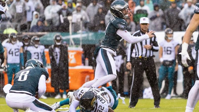 Oct 2, 2022; Philadelphia, Pennsylvania, USA; Philadelphia Eagles place kicker Jake Elliott (4) is run into by Jacksonville Jaguars cornerback Tyson Campbell (32) while attempting a field goal during the third quarter at Lincoln Financial Field. Mandatory Credit: Bill Streicher-USA TODAY Sports