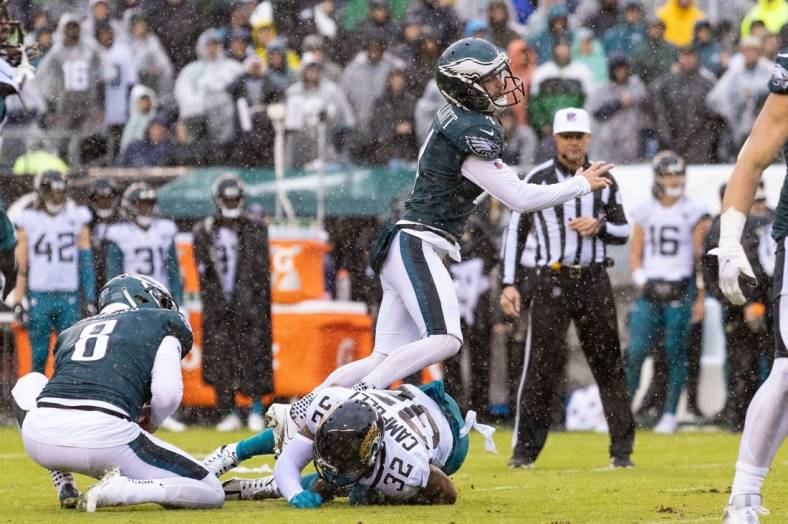 Oct 2, 2022; Philadelphia, Pennsylvania, USA; Philadelphia Eagles place kicker Jake Elliott (4) is run into by Jacksonville Jaguars cornerback Tyson Campbell (32) while attempting a field goal during the third quarter at Lincoln Financial Field. Mandatory Credit: Bill Streicher-USA TODAY Sports
