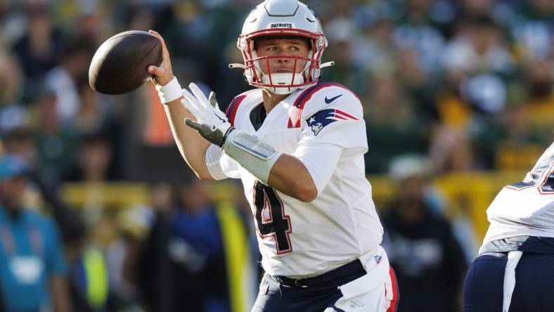 Oct 2, 2022; Green Bay, Wisconsin, USA;  New England Patriots quarterback Bailey Zappe (4) throws a pass during the second quarter against the Green Bay Packers at Lambeau Field. Mandatory Credit: Jeff Hanisch-USA TODAY Sports