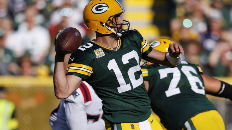 Oct 2, 2022; Green Bay, Wisconsin, USA;  Green Bay Packers quarterback Aaron Rodgers (12) throws a pass during the second quarter against the New England Patriots at Lambeau Field. Mandatory Credit: Jeff Hanisch-USA TODAY Sports