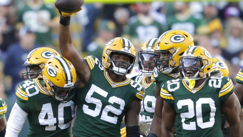 Oct 2, 2022; Green Bay, Wisconsin, USA; Green Bay Packers linebacker Rashan Gary (52) celebrates with teammates after sacking New England Patriots quarterback Bailey Zappe (not pictured) during the first half at Lambeau Field. Mandatory Credit: Dan Powers/Appleton Post-Crescent-USA TODAY NETWORK-Wisconsin