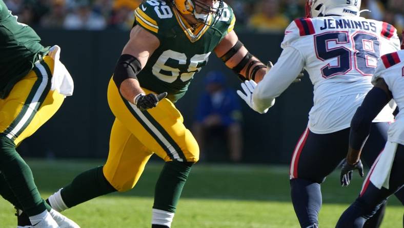 Oct 2, 2022; Green Bay, WI, USA;  Green Bay Packers lineman David Bakhtiari (69) looks to block New England Patriots linebacker Anfernee Jennings (58) during the first quarter of their game Sunday, October 2, 2022 at Lambeau Field in Green Bay, Wis. Mandatory Credit: Mark Hoffman-USA TODAY Sports