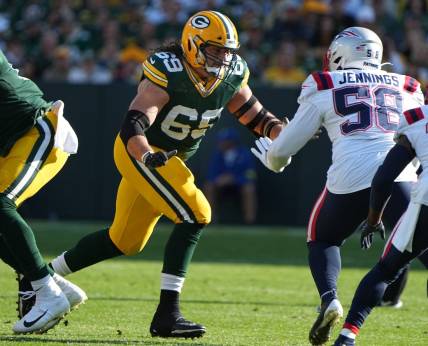 Oct 2, 2022; Green Bay, WI, USA;  Green Bay Packers lineman David Bakhtiari (69) looks to block New England Patriots linebacker Anfernee Jennings (58) during the first quarter of their game Sunday, October 2, 2022 at Lambeau Field in Green Bay, Wis. Mandatory Credit: Mark Hoffman-USA TODAY Sports