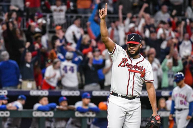 Oct 2, 2022; Cumberland, Georgia, USA; Atlanta Braves closing pitcher Kenley Jansen (74) reacts after striking out the final batter against the New York Mets in the ninth inning at Truist Park. Mandatory Credit: Larry Robinson-USA TODAY Sports