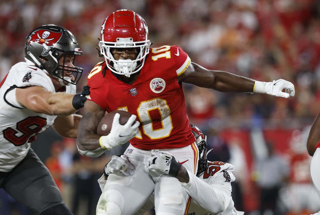 Oct 2, 2022; Tampa, Florida, USA; Kansas City Chiefs running back Isiah Pacheco (10) runs with the ball as Tampa Bay Buccaneers linebacker Shaquil Barrett (58) defends during the first half at Raymond James Stadium. Mandatory Credit: Kim Klement-USA TODAY Sports