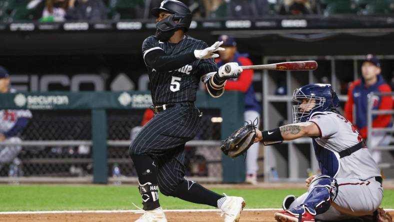 Oct 3, 2022; Chicago, Illinois, USA; Chicago White Sox second baseman Josh Harrison (5) hits a two-run home run against the Minnesota Twins during the second inning at Guaranteed Rate Field. Mandatory Credit: Kamil Krzaczynski-USA TODAY Sports