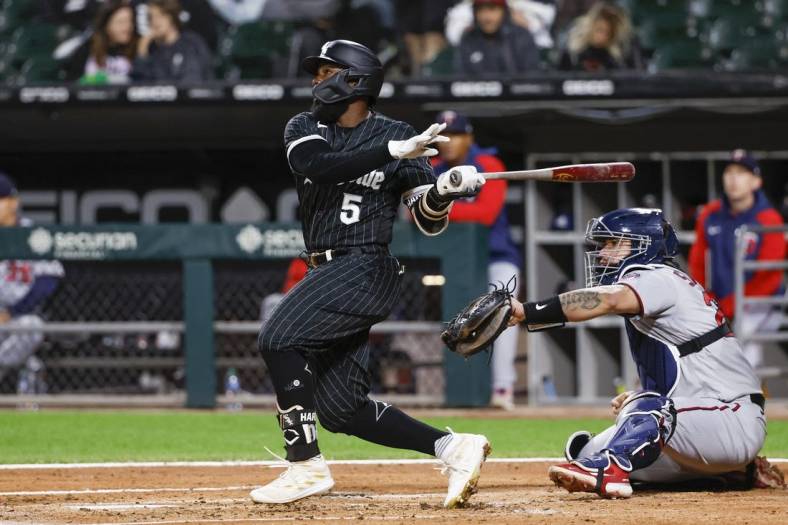 Oct 3, 2022; Chicago, Illinois, USA; Chicago White Sox second baseman Josh Harrison (5) hits a two-run home run against the Minnesota Twins during the second inning at Guaranteed Rate Field. Mandatory Credit: Kamil Krzaczynski-USA TODAY Sports